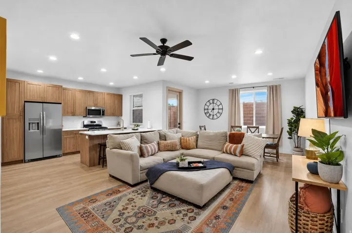 Open concept living space featuring wood-finish flooring, recessed lighting, and a ceiling fan