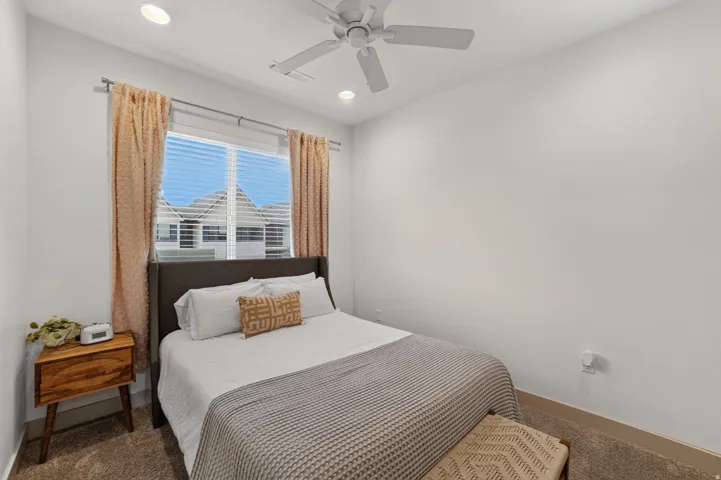 Window with blinds and drapes, ceiling fan, recessed lighting, wall-to-wall carpeting, and light-colored walls