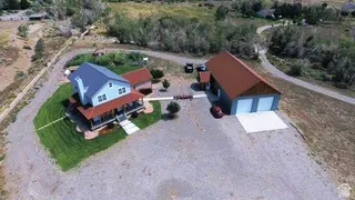 Two-story residence with a metal roof and light blue siding