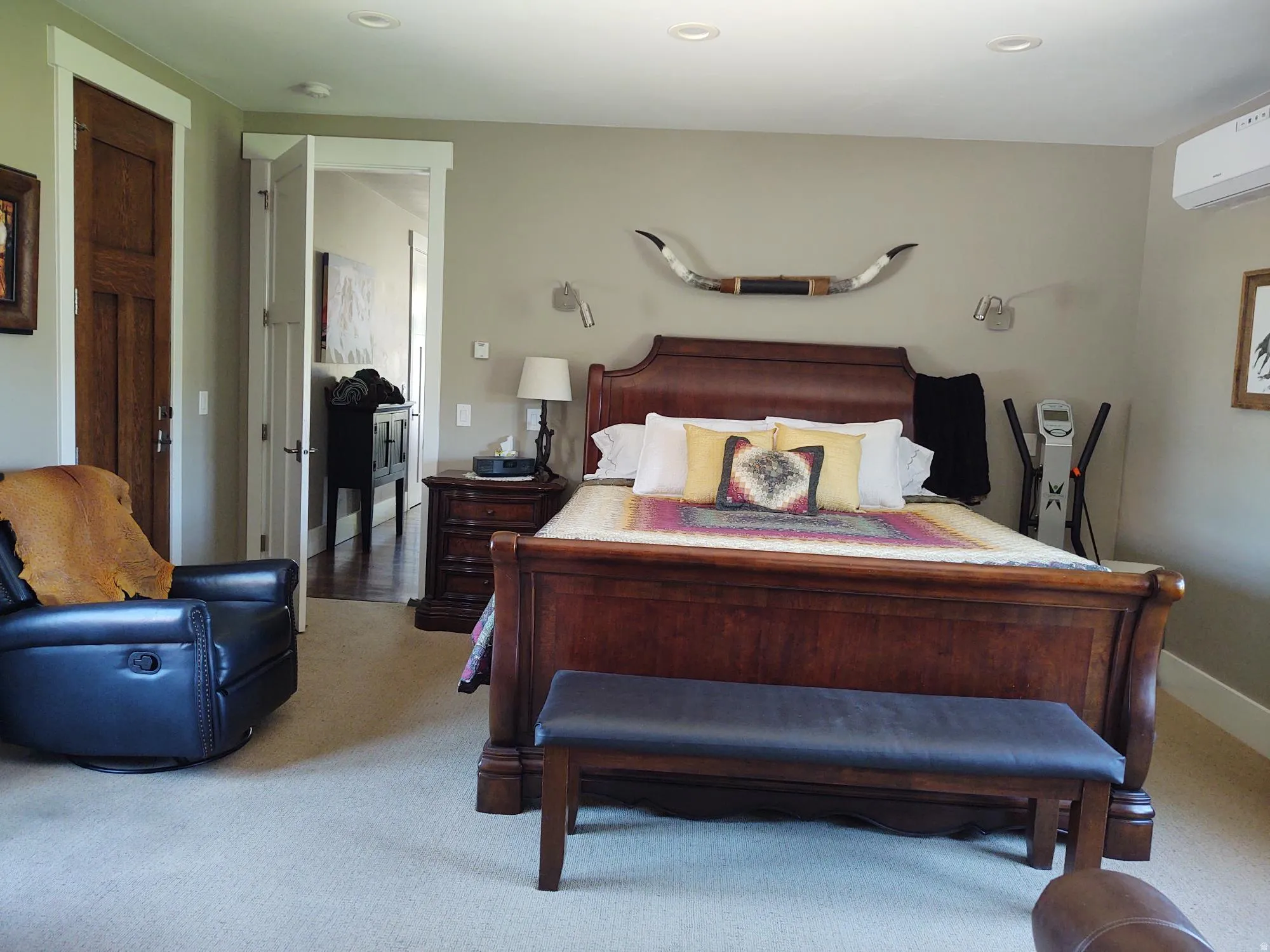 Recessed ceiling lighting, carpeted flooring, built-in air conditioning unit, solid core interior doors, and substantial white trim work