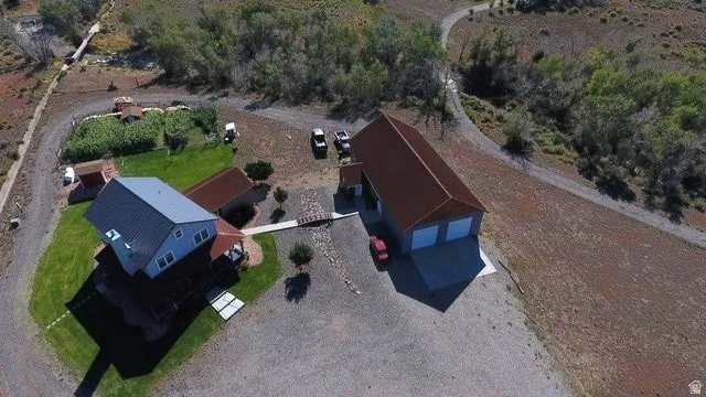 Aerial view showcasing a multi-building property set on expansive grounds with mature landscaping