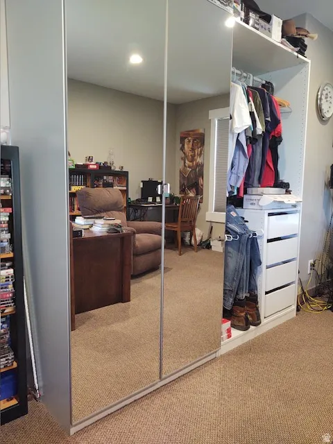 Mirrored sliding wardrobe doors with an integrated open shelving system, featuring multiple hanging rods and white drawer units