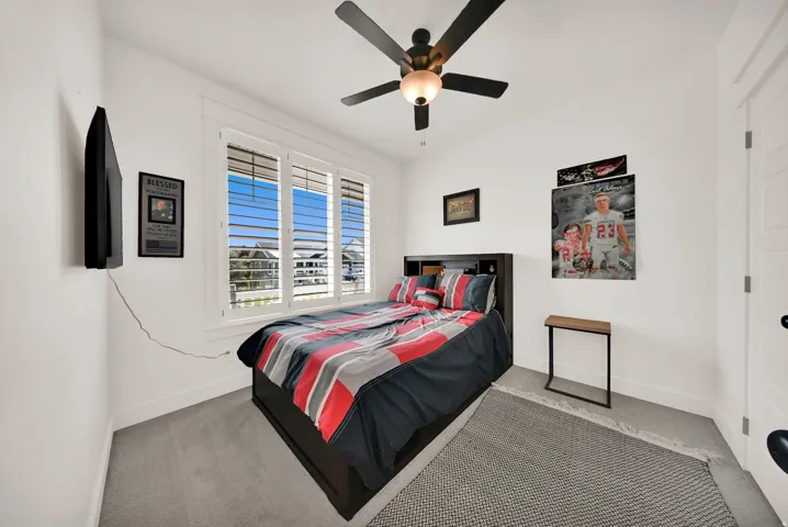 White walls complement window shutters and ceiling fan