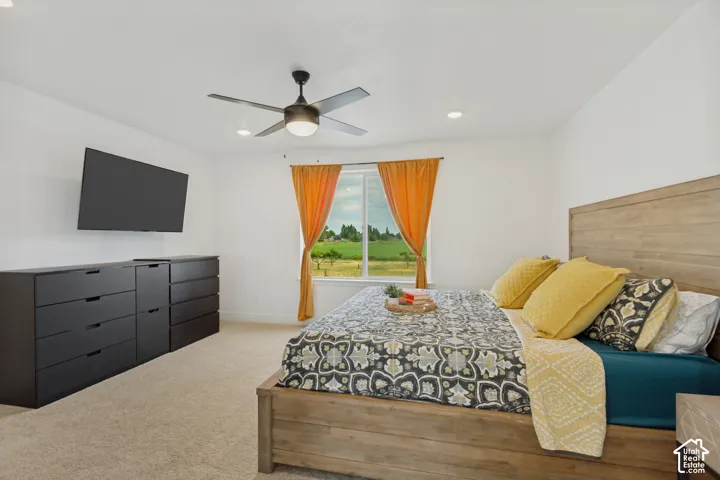 Recessed lighting, ceiling fan, and carpeted flooring