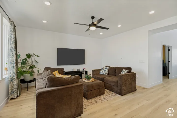 Bright interior space featuring light wood-finish flooring, recessed lighting, and a ceiling fan