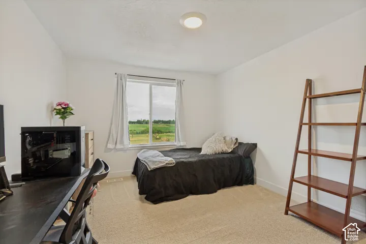 Recessed ceiling light, carpeted flooring, white walls, and a window with white trim