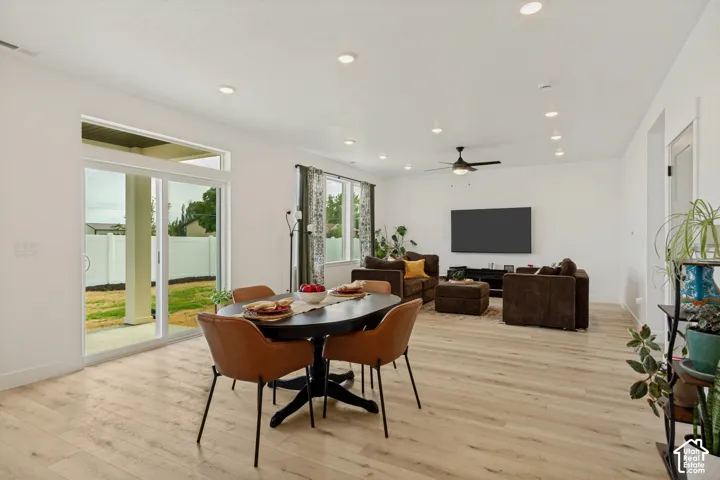Open-concept living space featuring wood-finish flooring, recessed lighting, and a ceiling fan