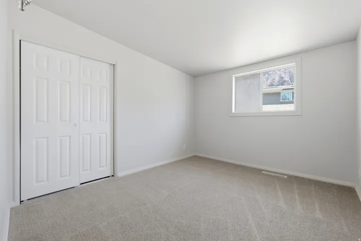 Bedroom 2 featuring neutral carpeting and white walls
