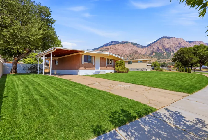 Brick exterior residence with a covered carport.   Digitally altered to enhance the appearance of the front lawn. Grass condition at time of showing may vary.