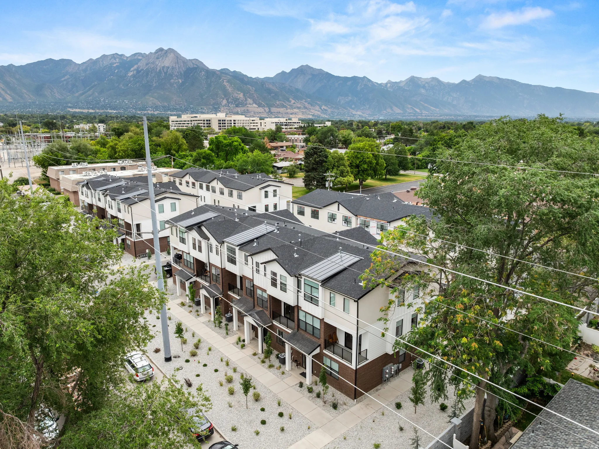 Modern townhome community featuring multi-level residences with contrasting exterior finishes