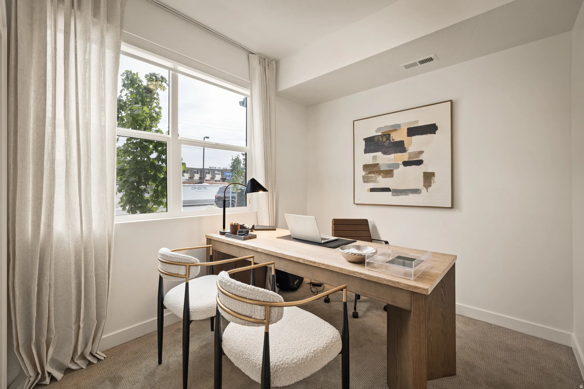 Large window with white frame, light-toned walls, and carpeted flooring