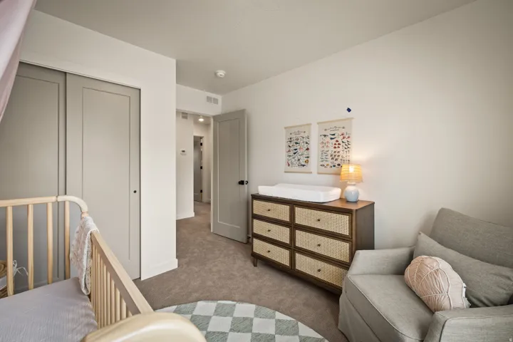 Recessed lighting, light-colored walls, and neutral carpeting