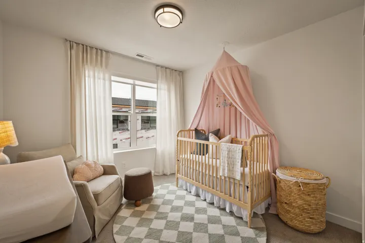 Recessed lighting fixture, light-toned wall paint, and double-paned window with sheer curtains