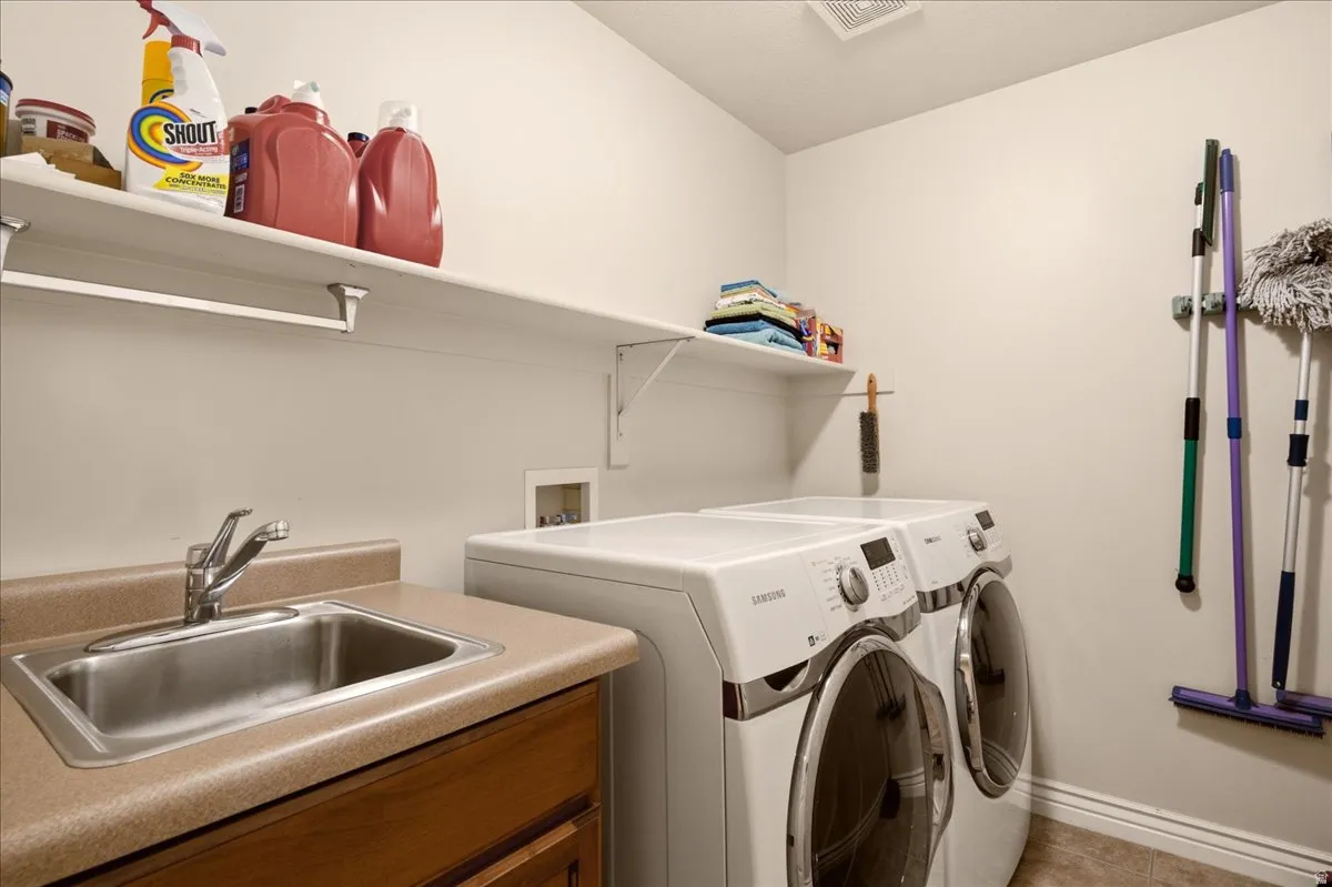 Spacious laundry room with sink.