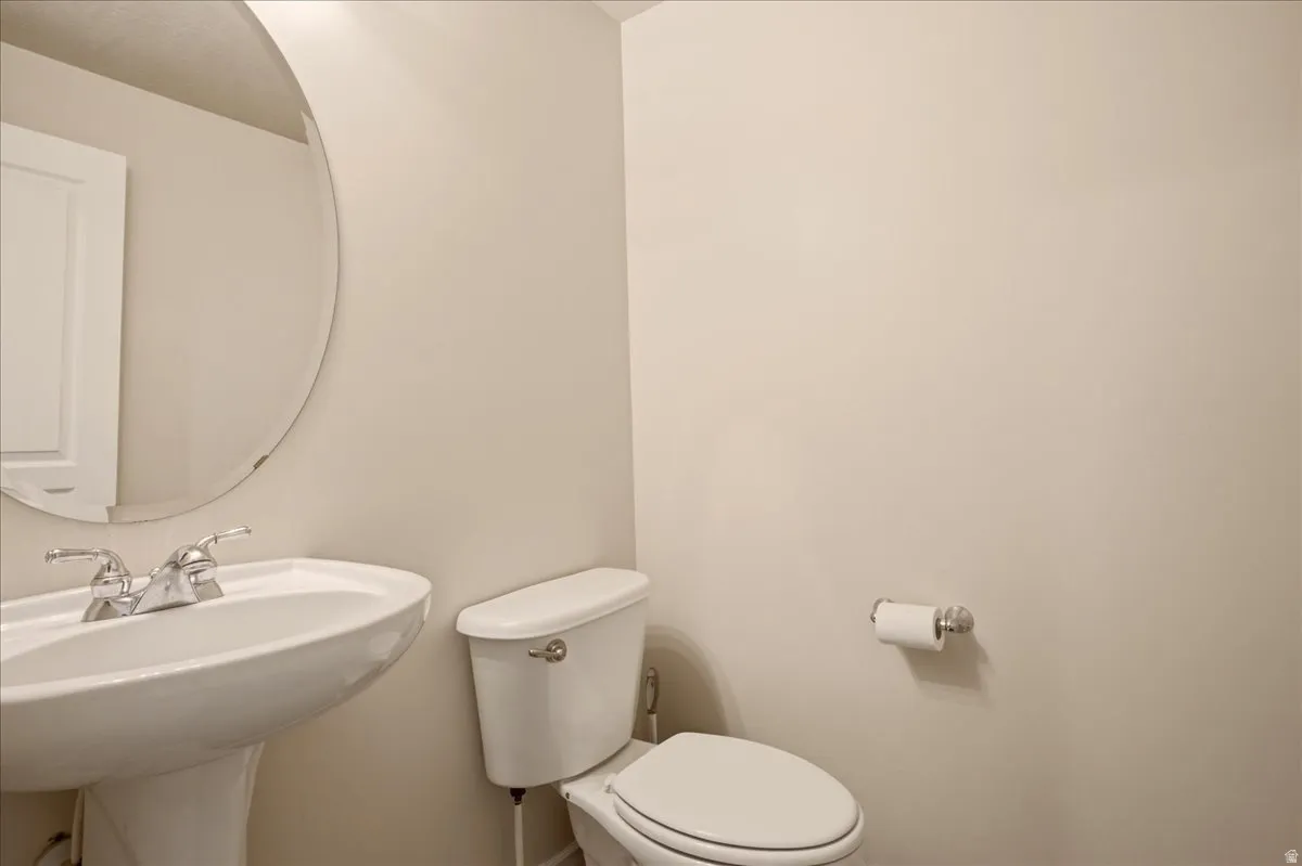 Half bathroom off the kitchen and garage