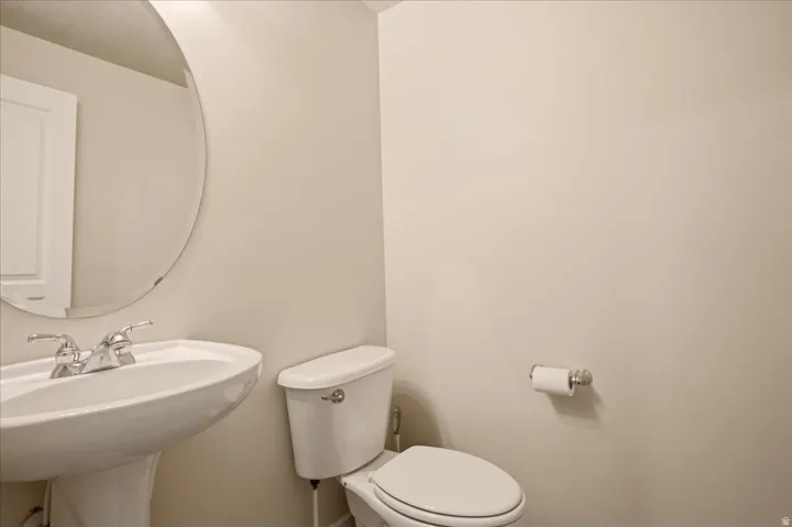 Half bathroom off the kitchen and garage