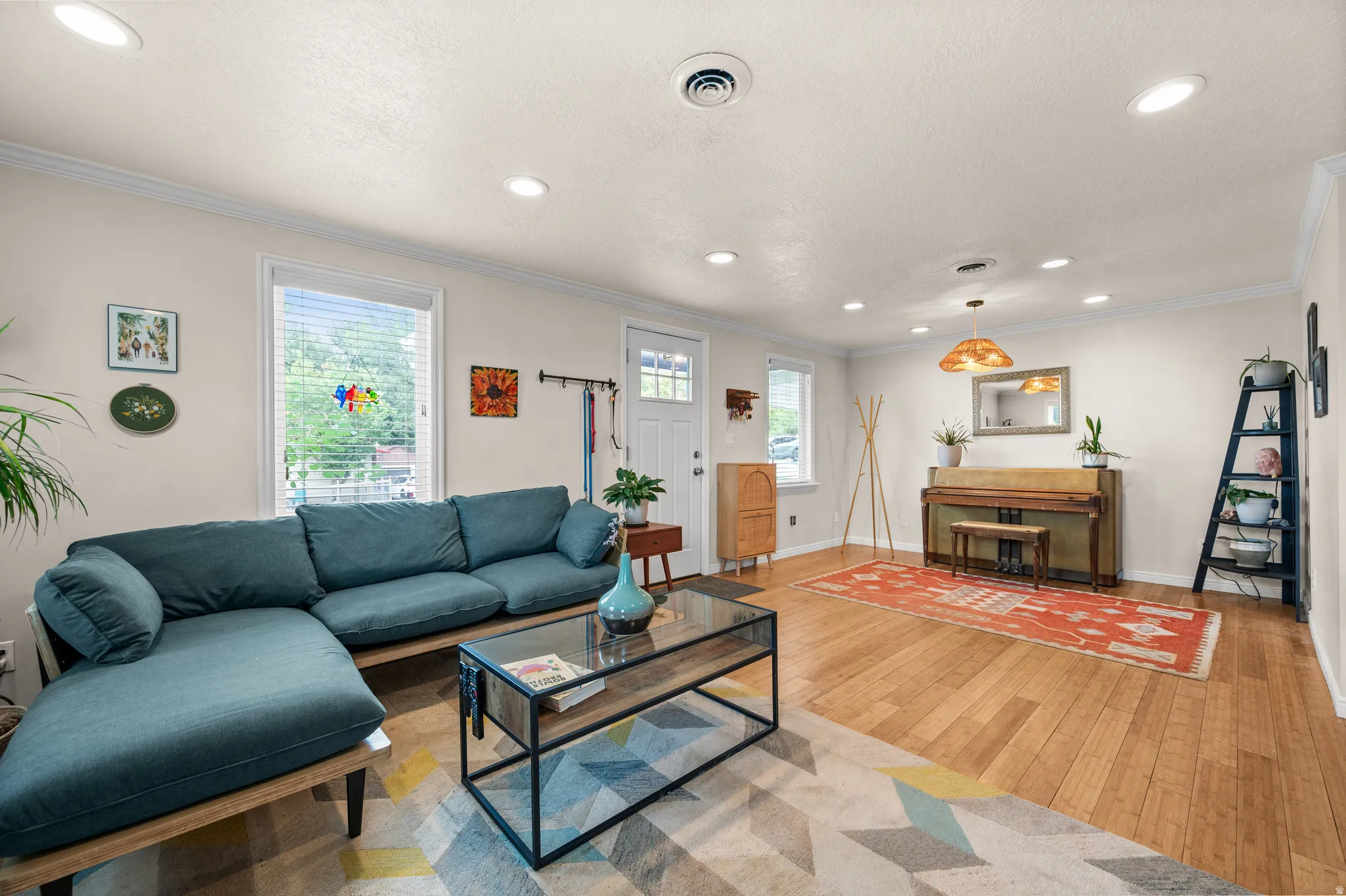 Recessed lighting, wood-finish flooring, crown molding, and multiple windows