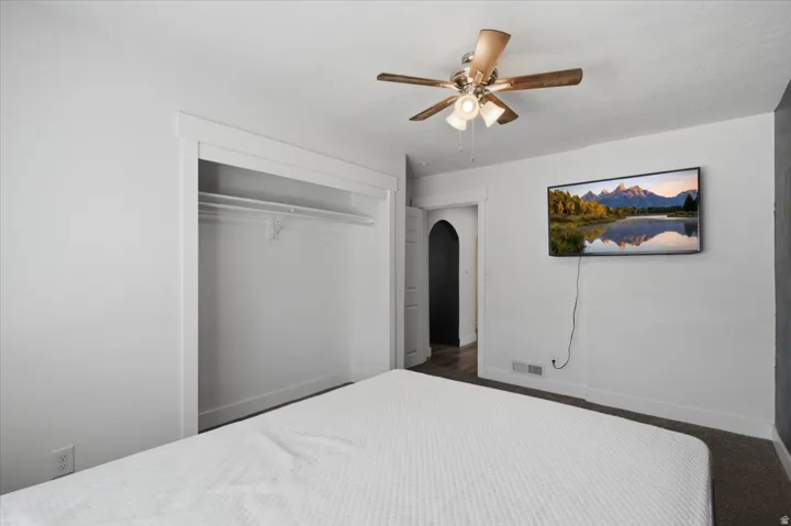White walls with an integrated closet featuring a single hanging rod