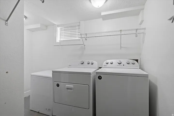 Laundry area with wire shelving, window, and flush mount lighting
