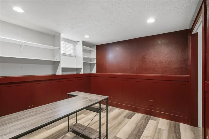 Recessed lighting, built-in shelving, wood-finish flooring, wainscoting