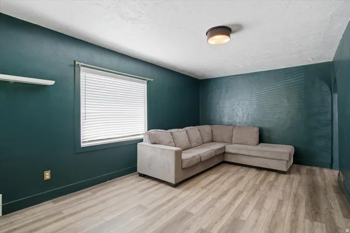 Wood-finish flooring, recessed lighting, and a window with blinds