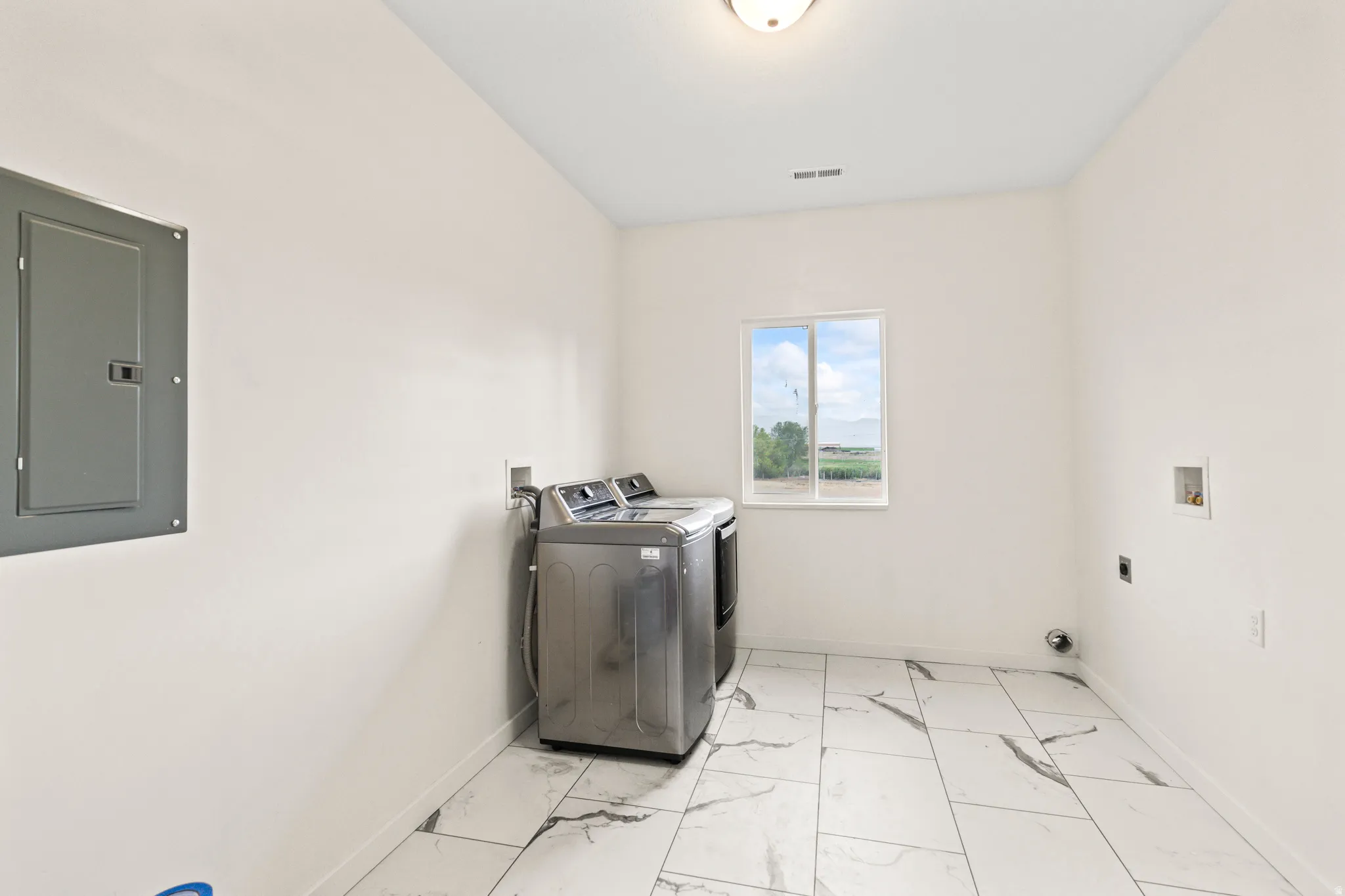 White walls, white ceiling, window, flush mount ceiling light, electrical panel
