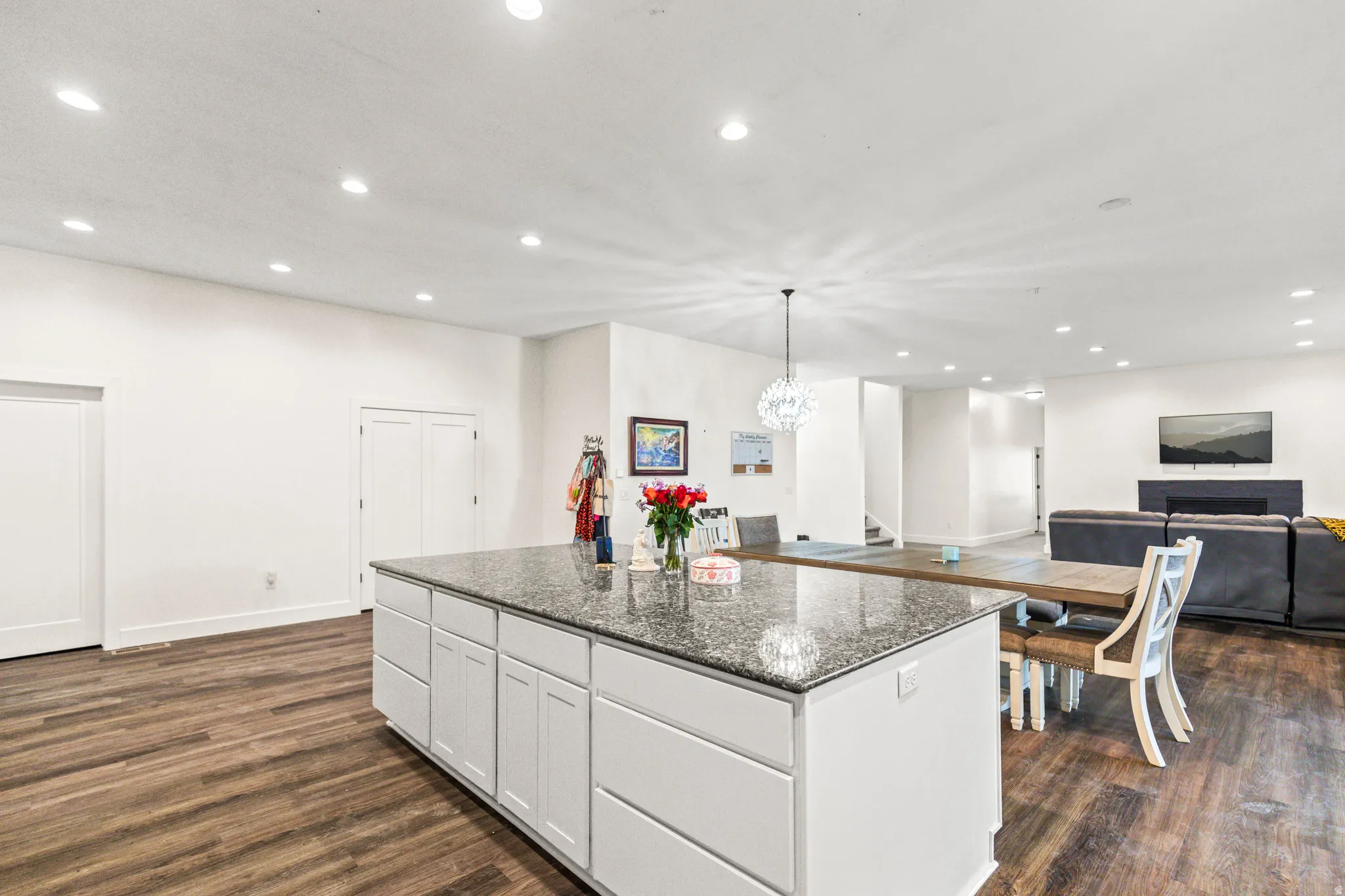 Spacious kitchen island with light cabinetry and a stone-finish countertop