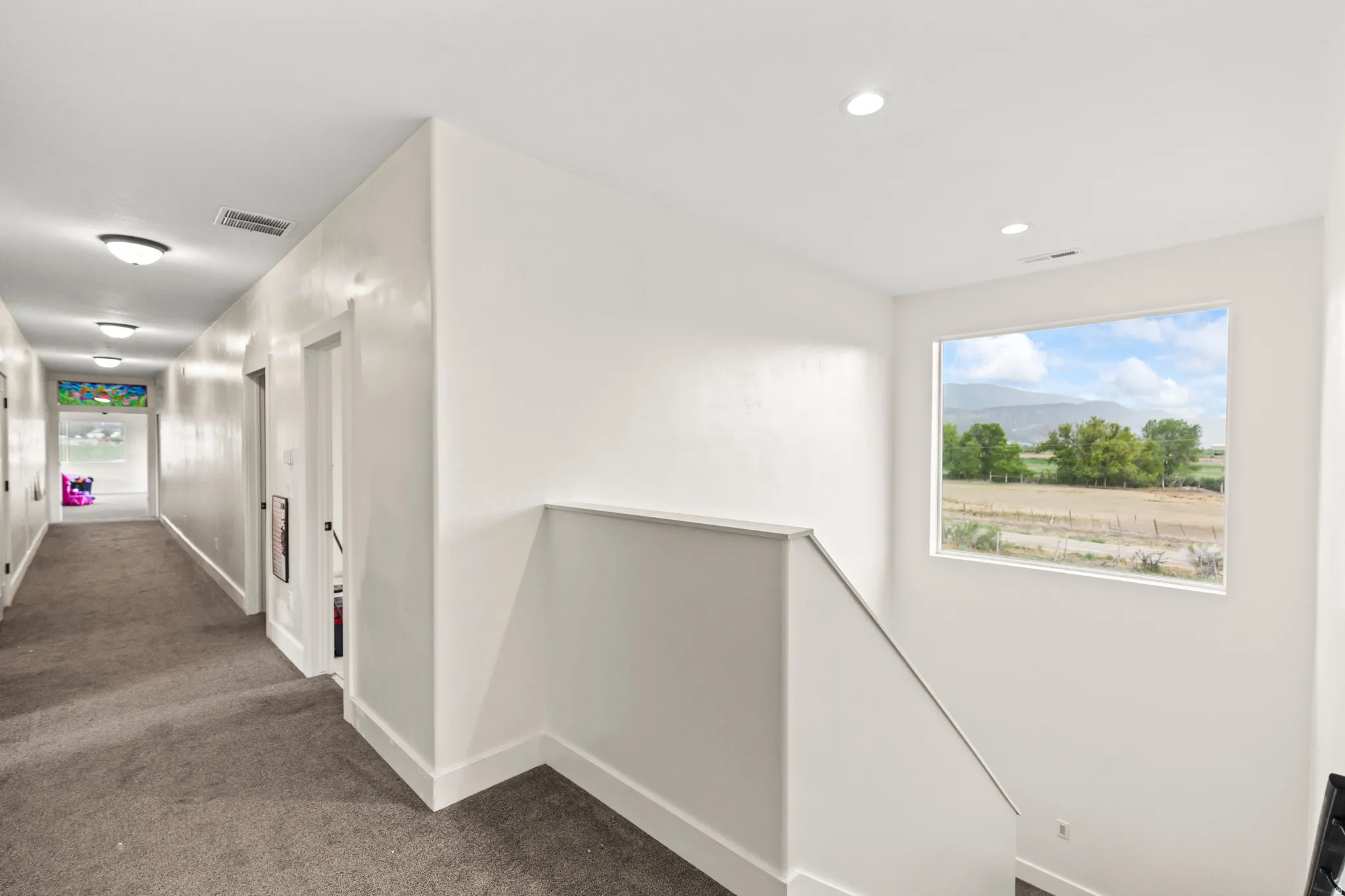 Hallway featuring recessed lighting, flush-mount ceiling fixtures, and carpet flooring