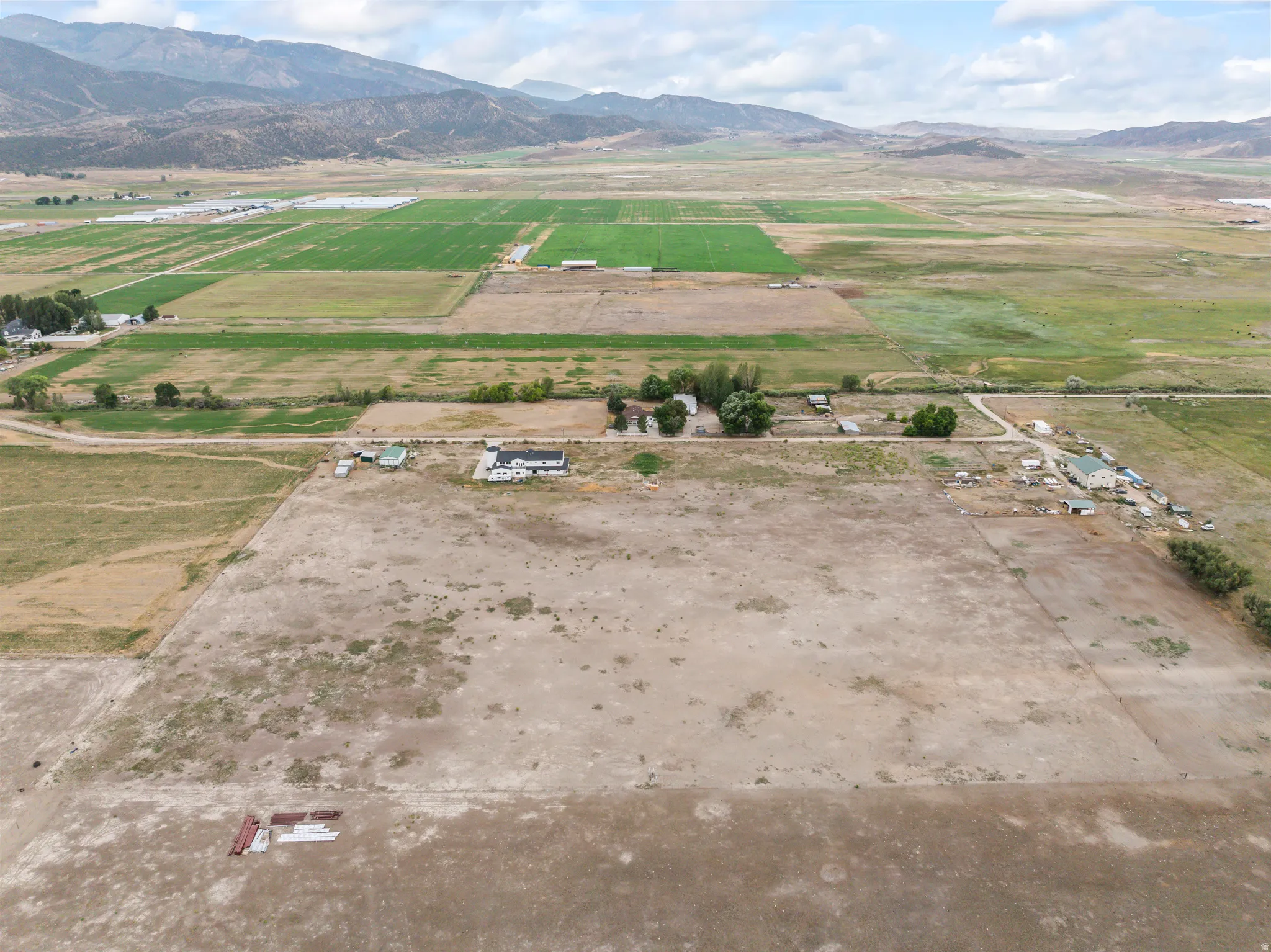 Expansive agricultural land with a rural setting and distant mountains