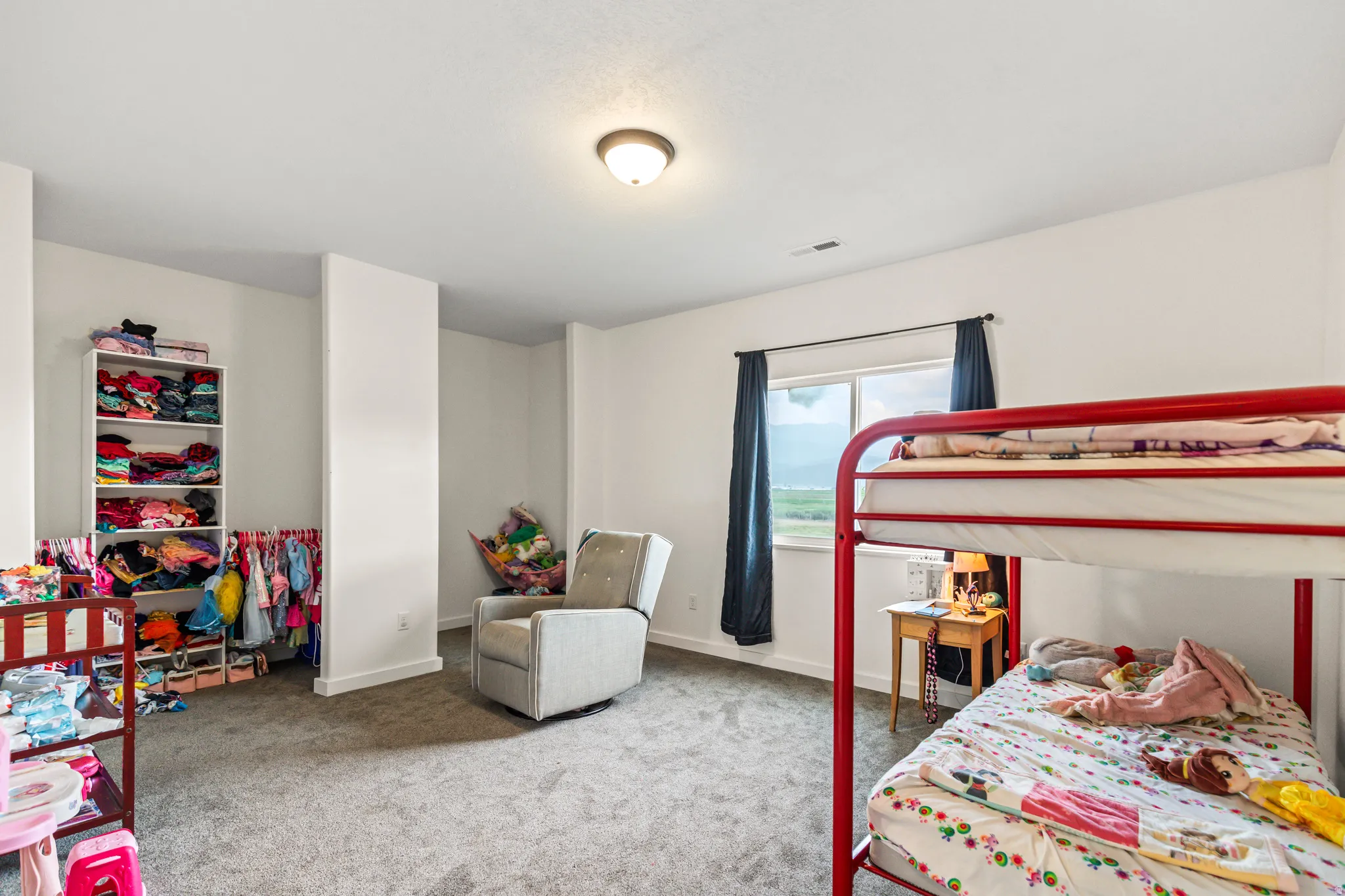 Carpeted room featuring a single window and recessed wall sections