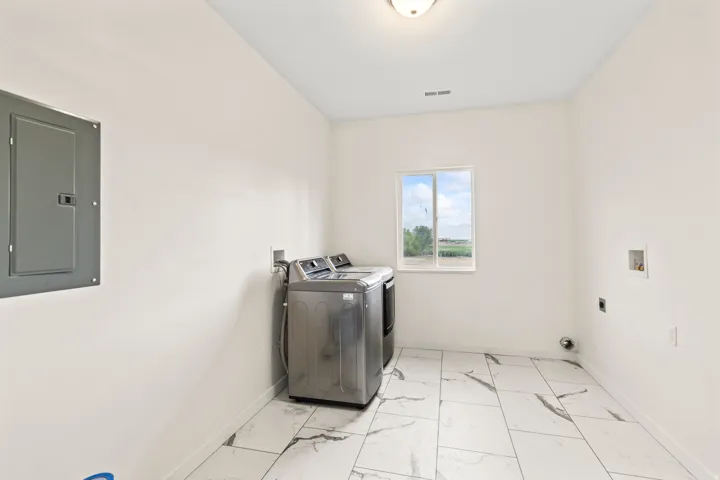 White walls, white ceiling, window, flush mount ceiling light, electrical panel