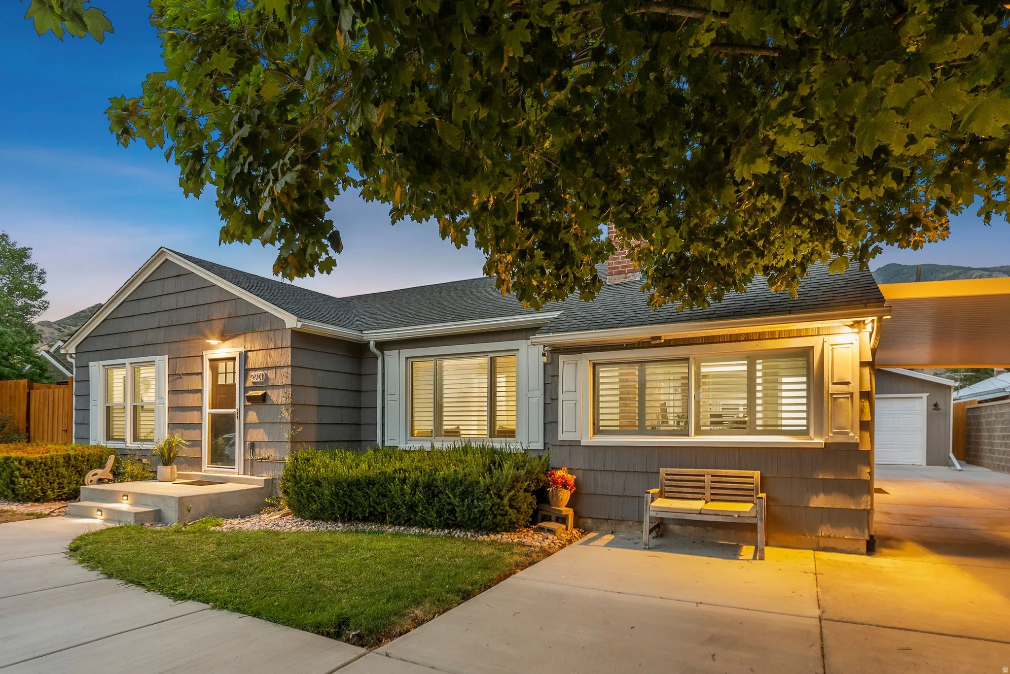 Shingle siding exterior with white window trim and shutters
