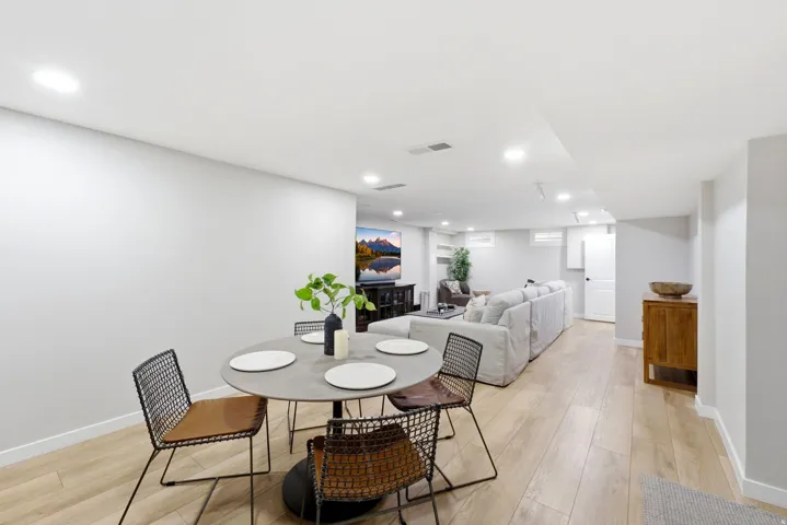 Recessed lighting, light wood-finish flooring, white walls, and a white ceiling
