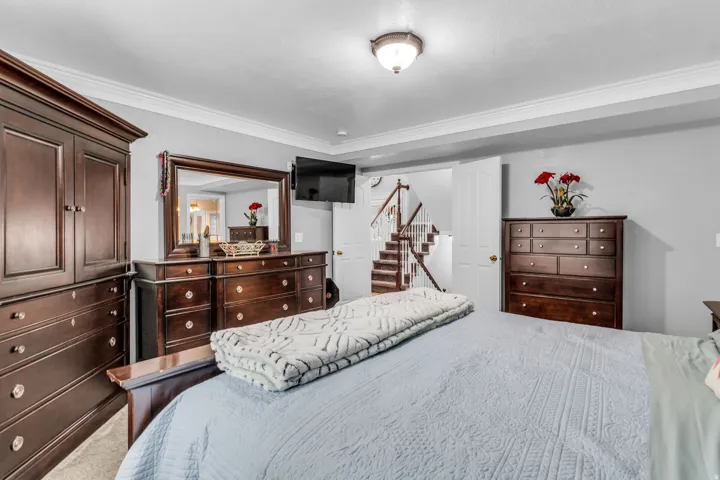 Recessed lighting, crown molding, and neutral wall tones create a refined aesthetic