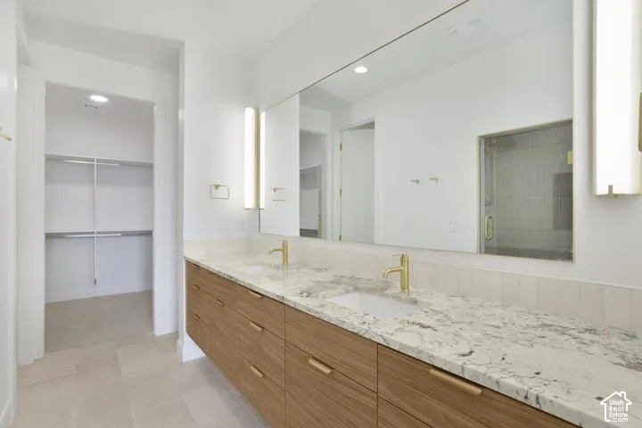 Dual vanity with wood-finish cabinetry and stone countertops