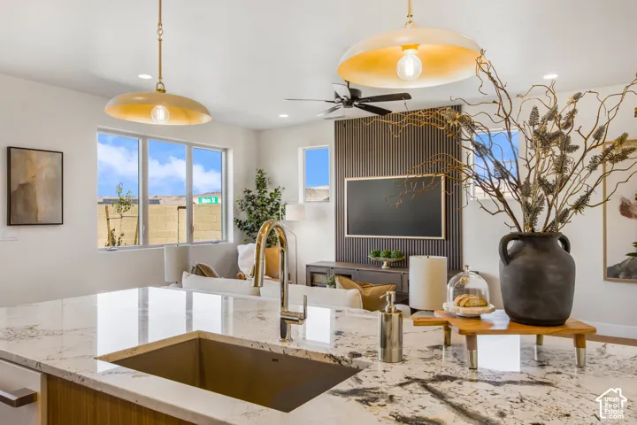 Kitchen island with an undermount sink, a gooseneck faucet, and integrated appliances