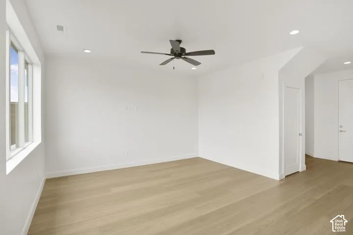Recessed lighting, wood-finish flooring, white walls, ceiling fan, and white trim throughout