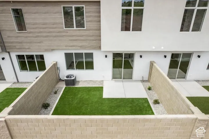 Modern exterior with white stucco finish, wood-look siding, multiple large windows, and sliding glass doors