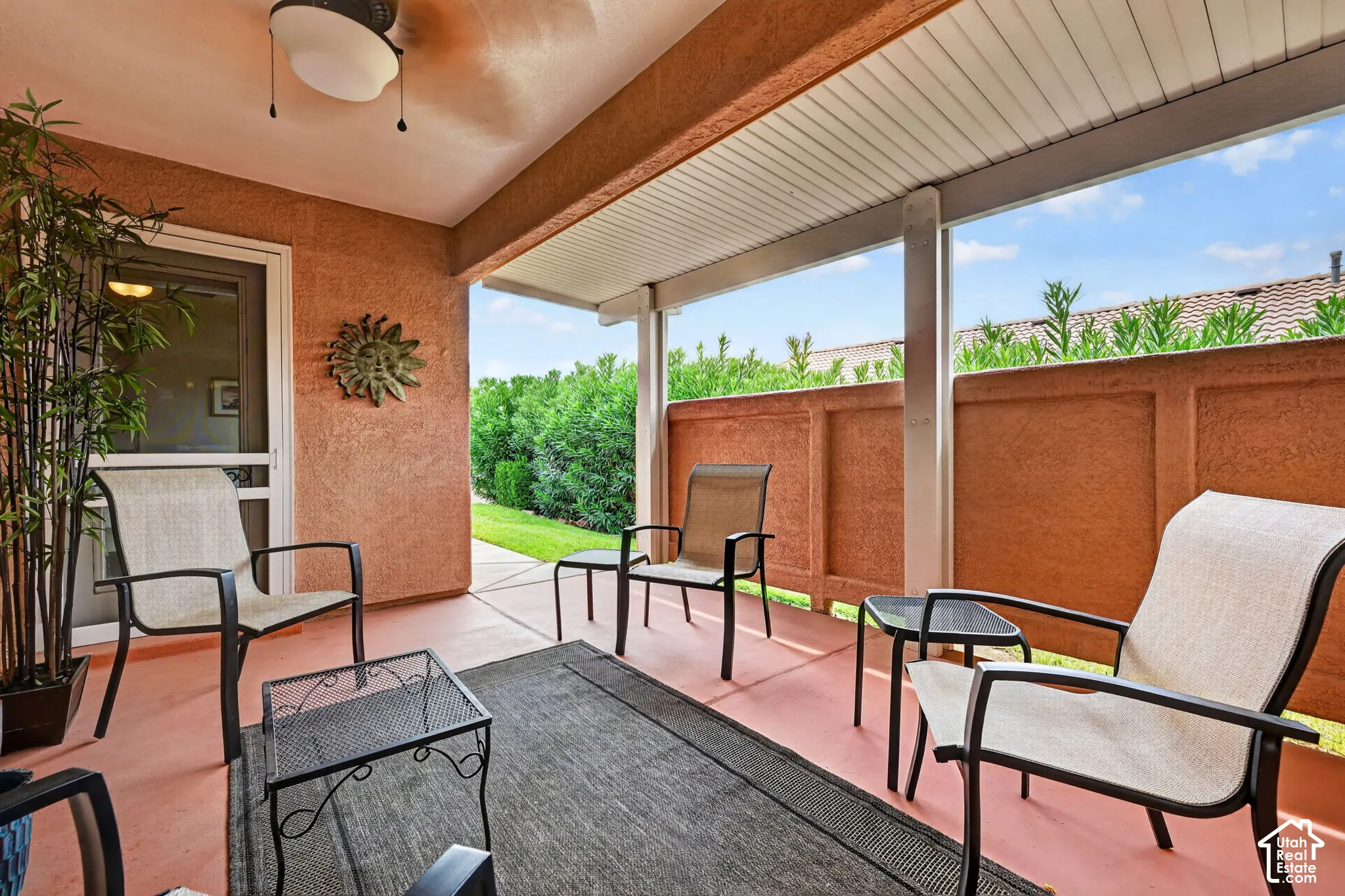 Covered patio with a textured ceiling and a mounted ceiling fan