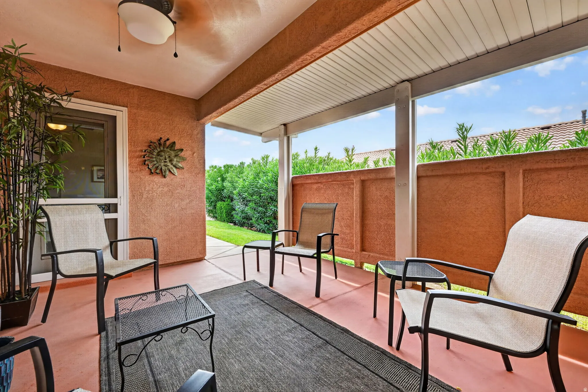 Covered patio with a textured ceiling and a mounted ceiling fan