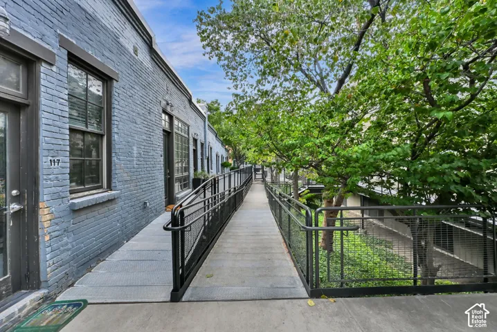 Grey brick exterior with black framed windows and doors