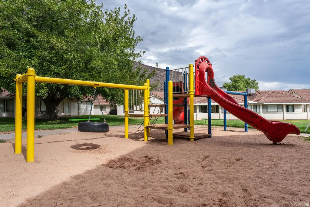 Playground area featuring a swing set, tire swing, and slide structure