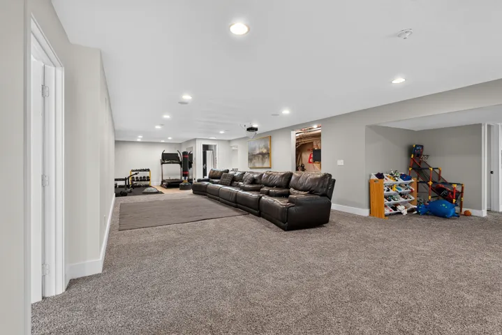 Expansive carpeted area with recessed lighting