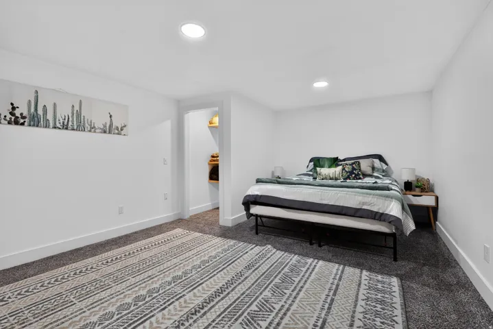 Plush carpeting, recessed lighting, and a white color palette