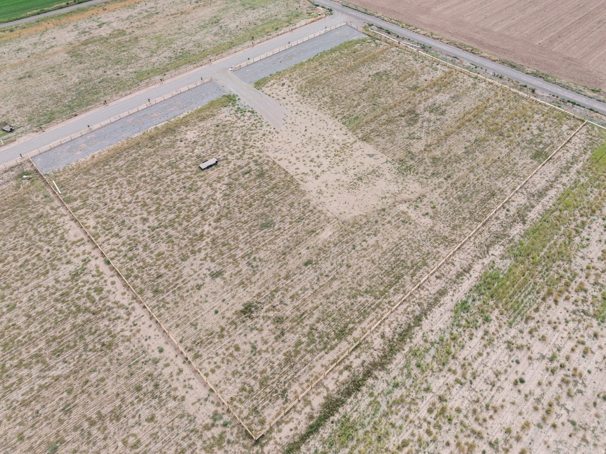 Expansive undeveloped lot with partial perimeter fencing