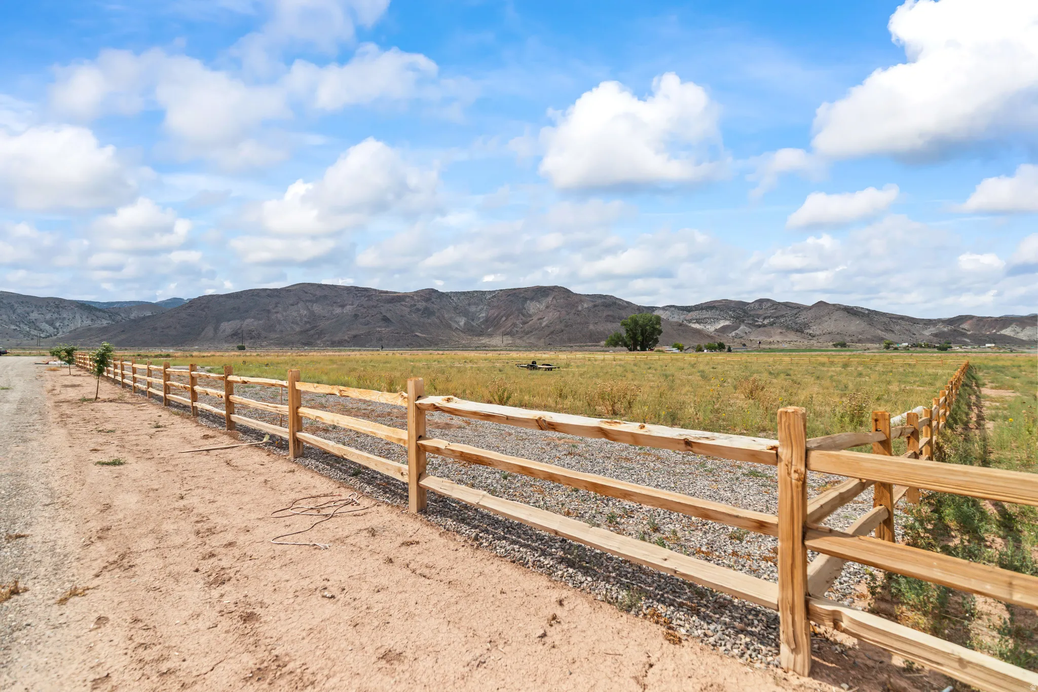 Expansive natural landscape with a rustic wood fence