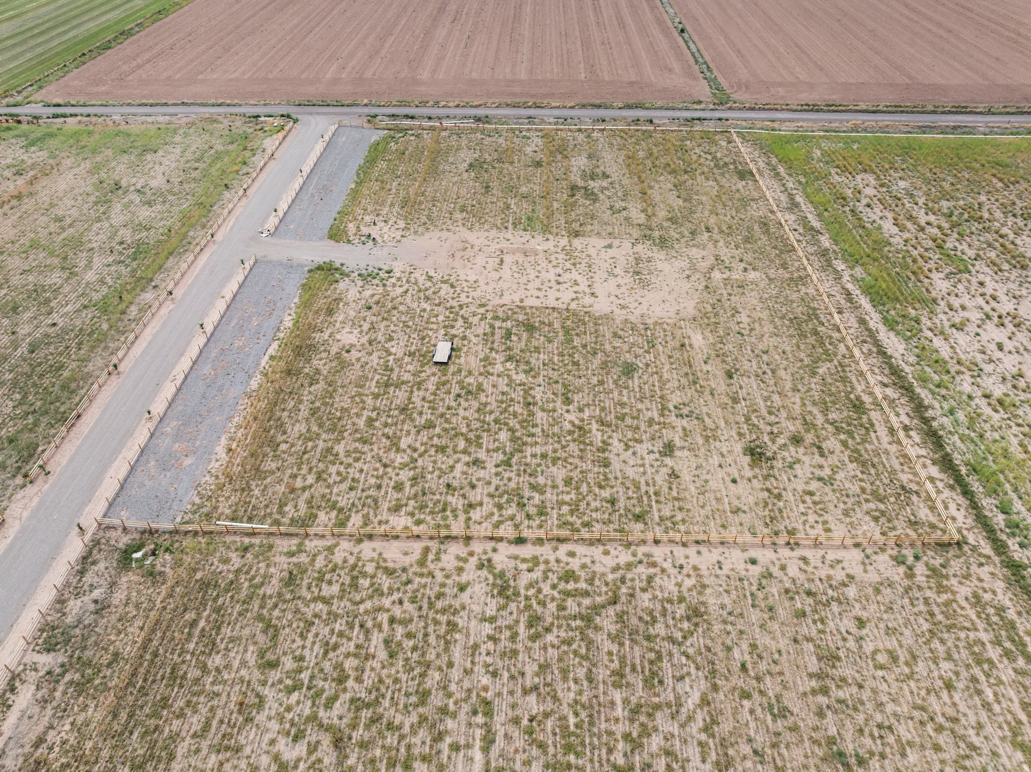 Expansive rural land parcel with established gravel roads and agricultural surroundings