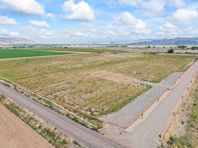 Expansive agricultural land with rural roads and distant mountain backdrop