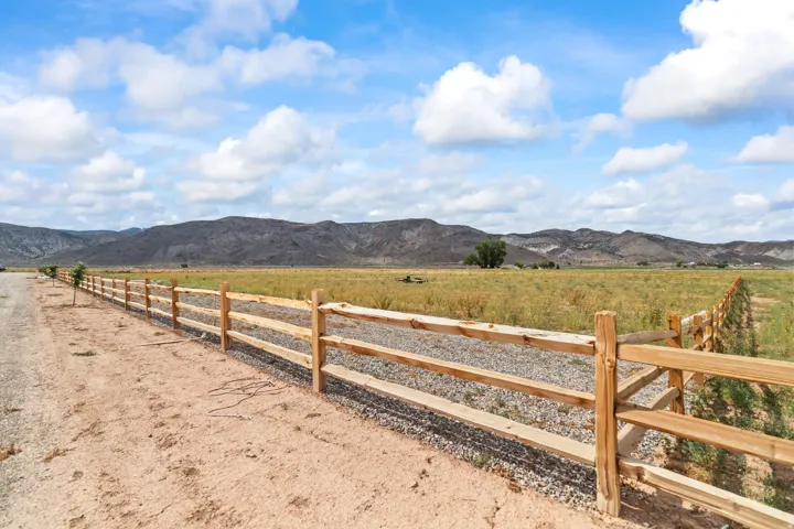Expansive natural landscape with a rustic wood fence