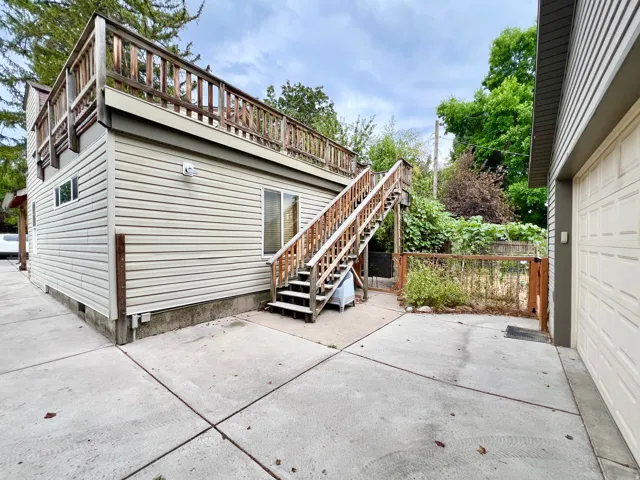 Exterior siding with a second-story wood deck and railing